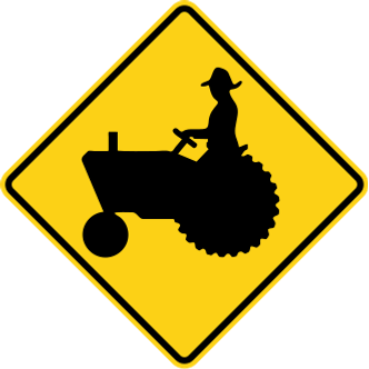 Farm Machinery sign: yellow diamond with a tractor and its driver.